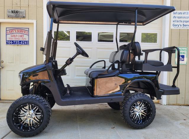 A golf cart with a wooden front and back seat.