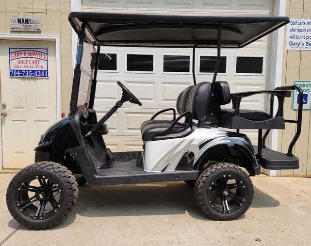 A golf cart with a black and silver color scheme.