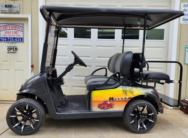 A golf cart with two seats and a steering wheel.