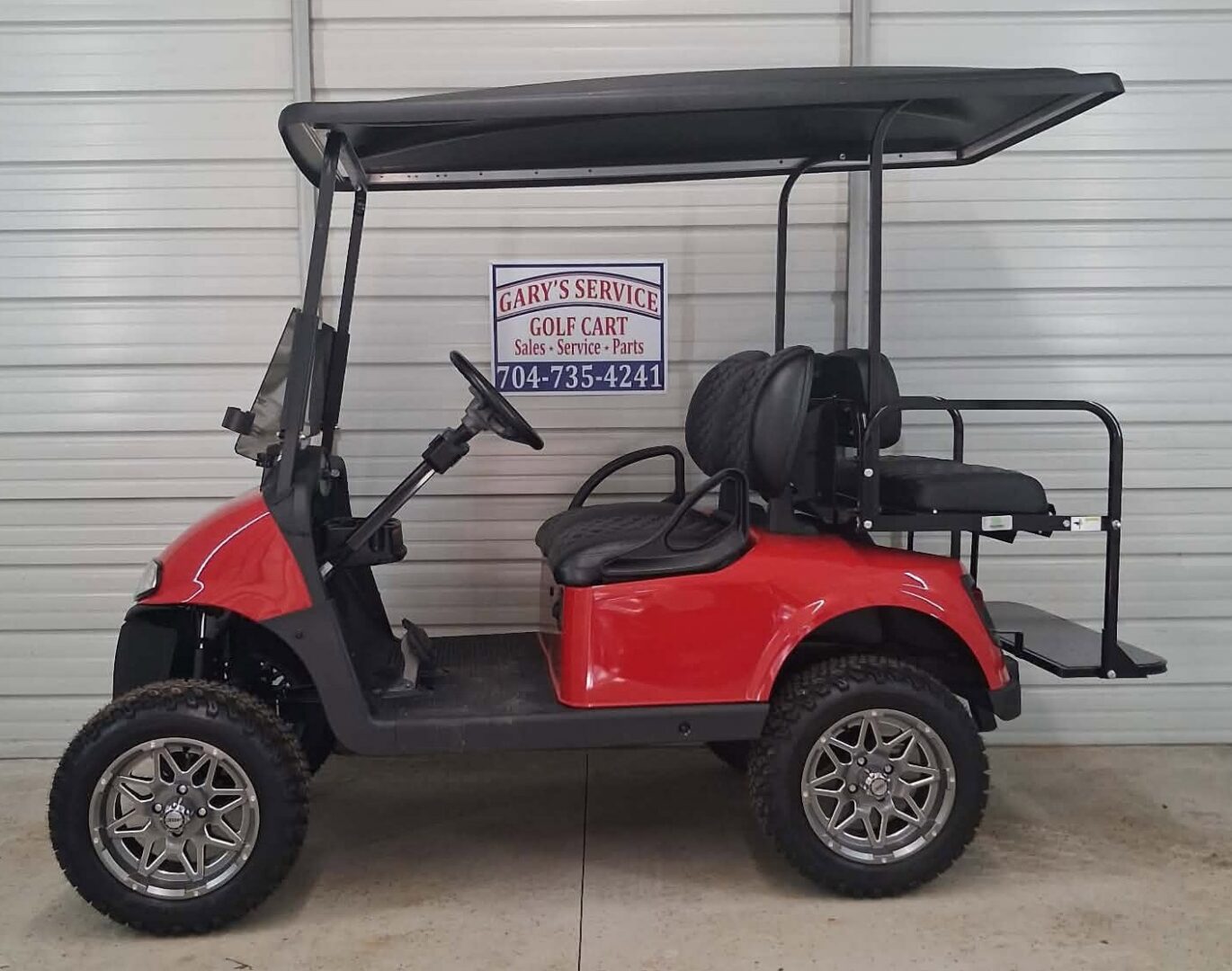 Red off-road golf cart with canopy