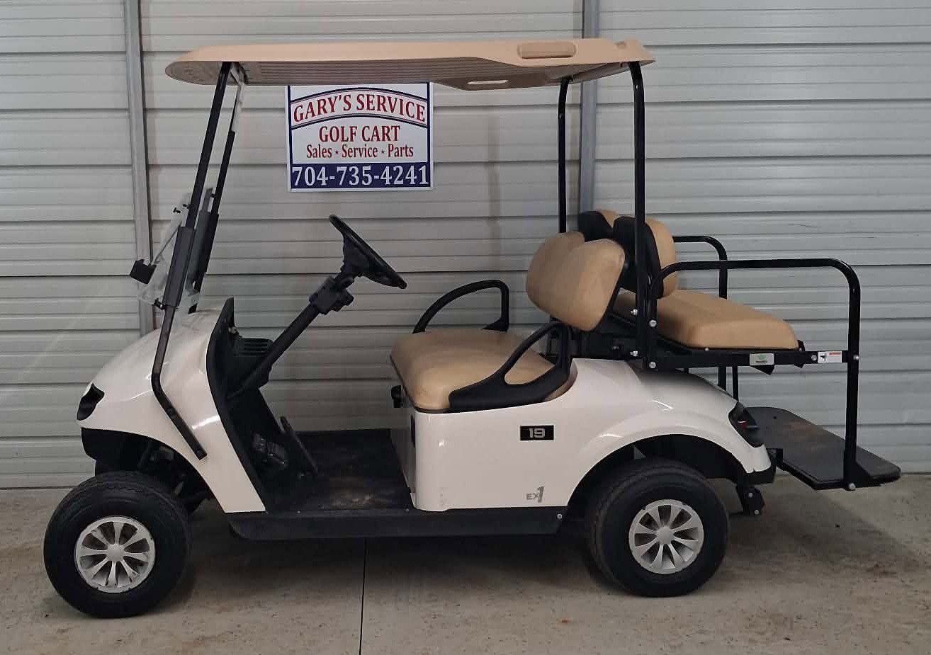 White golf cart with tan seats